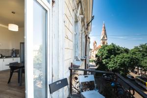 a balcony with a view of a church at апарт-готель у Кірхи in Odesa