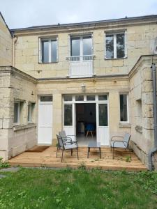 a house with two chairs on a wooden deck at HISTOIRE DE LOIRE - La Maison in Saumur