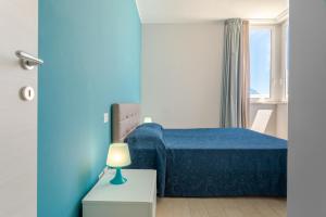 Ένα ή περισσότερα κρεβάτια σε δωμάτιο στο Case vacanze Blue Bay Resort +78 φωτογραφίες