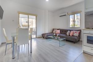 a living room with a couch and a table at Downtown Larnaca in Larnaca