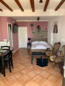 a bedroom with a bed and a table and chairs at Apartment ILI in Piran