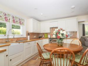 a kitchen with a table with a vase of flowers on it at Applegarth in Scarborough