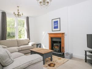 a living room with a couch and a fireplace at Applegarth in Scarborough