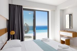 a bedroom with a bed and a view of the ocean at Falasarna village in Falasarna