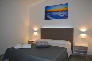 Postel nebo postele na pokoji v ubytování Valle degli Ulivi B&B