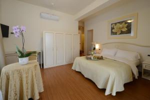 Postel nebo postele na pokoji v ubytování Hotel Viscardo