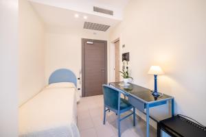 Säng eller sängar i ett rum på Hotel Il Gabbiano