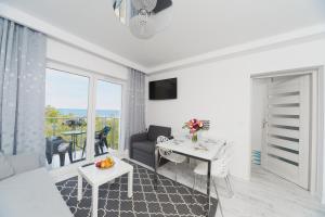 TV a/nebo společenská místnost v ubytování Porta Mare Apartments LuxView III