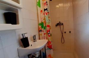 a bathroom with a sink and a shower at Shell in Rogoznica