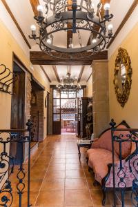 a large bedroom with a chandelier and a bed at Casa rural dels Hospitalaris in Traiguera