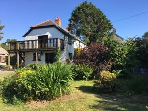 a house with a deck on the side of it at Slerra Hill Bed and Breakfast, Clovelly in Bideford