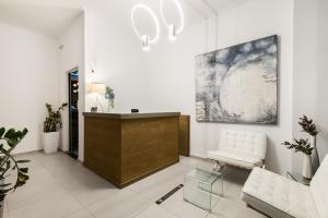 a living room with a white couch and a table at Klimis Hotel in Spetses