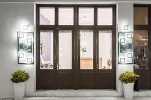 a door to a pharmacy with signs on it at Klimis Hotel in Spetses