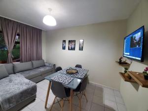 a living room with a couch and a table at Vila Emilio in Udënisht