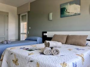 ein Schlafzimmer mit einem Bett mit Handtüchern darauf in der Unterkunft Dukes Habitaciones in Bascuas