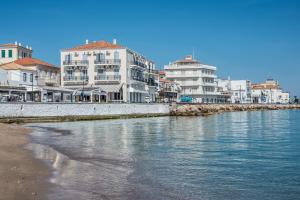 a group of buildings next to a body of water at Klimis Hotel in Spetses