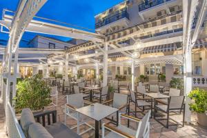 a view of the patio of a hotel with tables and chairs at Klimis Hotel in Spetses