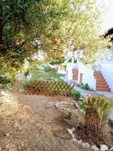 a garden with a fence and an umbrella at Level Houses in Kefalos