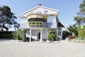 a white house with a large driveway at Apartments Titonel in Savudrija