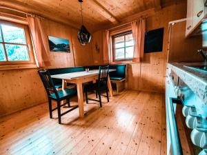 Ferienhaus Berger في فيرجن: غرفة طعام مع طاولة وكراسي خشبية