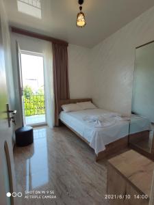 a bedroom with a bed and a large window at Kochalidze family in Batumi