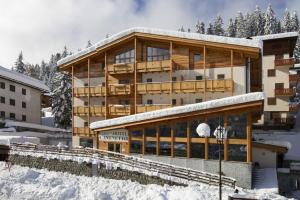 
a large building with a ski lift on top of it at Hotel Garnì Caminetto in Madonna di Campiglio
