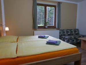 a bedroom with a bed with two towels on it at Pension Aspen Harrachov in Harrachov