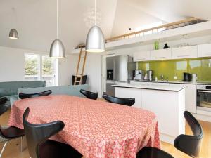 een keuken en eetkamer met een tafel en stoelen bij 10 person holiday home in Brovst in Tranum Strand