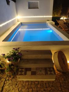 a swimming pool in the middle of a house at 4 Cantos in Faro