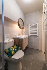 a bathroom with a toilet and a sink and a mirror at Scala_Apartment in Kalamata