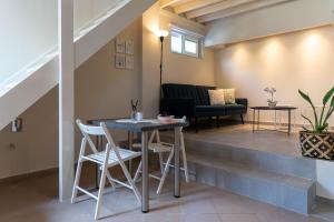 a living room with a table and chairs and a couch at Scala_Apartment in Kalamata