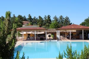 a large swimming pool in front of a resort at Tenuta il Giogo in Monterado