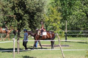 a woman riding on the back of a horse at Tenuta il Giogo in Monterado