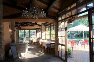 a dining room with a chandelier and tables and chairs at Tenuta il Giogo in Monterado