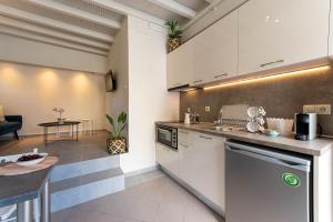 a kitchen with white cabinets and a counter top at Scala_Apartment in Kalamata
