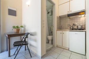 a small kitchen with a table and a sink at Geana Apartments in Chania +40 photos