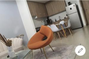 a kitchen with an orange chair in a room at TOWN SQUAR PARK VIEW in Dubai