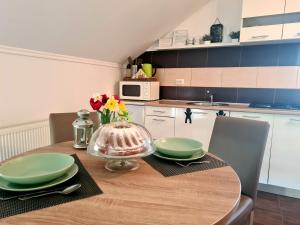 a kitchen with a wooden table with green dishes on it at Apartment Marin in Ogulin