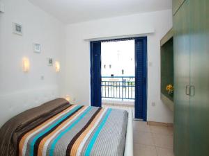 - une chambre avec un lit et une porte donnant sur un balcon dans l'établissement Villa Julie, à Protaras
