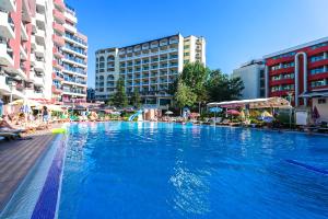 a large swimming pool in a city with buildings at Apartments in Hotel Admiral Plaza in Sunny Beach