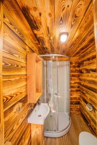
a bathroom with a tub and a sink at Yuryevskoye Podvorye Boutique Hotel in Velikiy Novgorod
