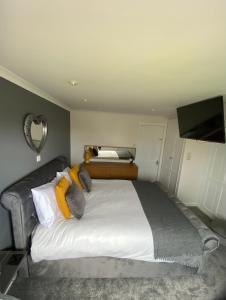 a bedroom with a large bed with yellow pillows at Craster Crew Quarters in Craster