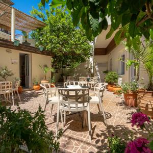 a patio with tables and chairs in a courtyard at Geana Apartments in Chania