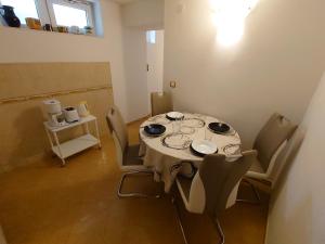 a dining room with a table with chairs at Apartmani Lea in Jadranovo