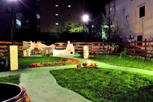 a garden at night with a pathway in the grass at Lazy House in Hengchun South Gate