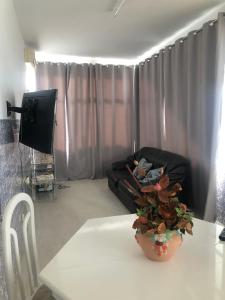 a living room with a table and a couch at Vivenda Ladeira in Olhão