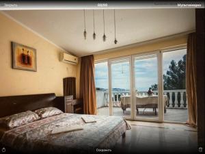 a bedroom with a bed and a view of a balcony at Imperia in Bar