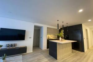 a kitchen with a island in the middle of a room at PRECIOSO APARTAMENTO A ESTRENAR EN CENTRO DE NERJA in Nerja