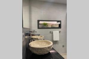 un baño con un gran lavabo de piedra. en PRECIOSO APARTAMENTO A ESTRENAR EN CENTRO DE NERJA, en Nerja