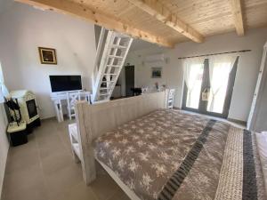 a bedroom with a bed and a tv and a ladder at Apartment I&M in Plitvička Jezera